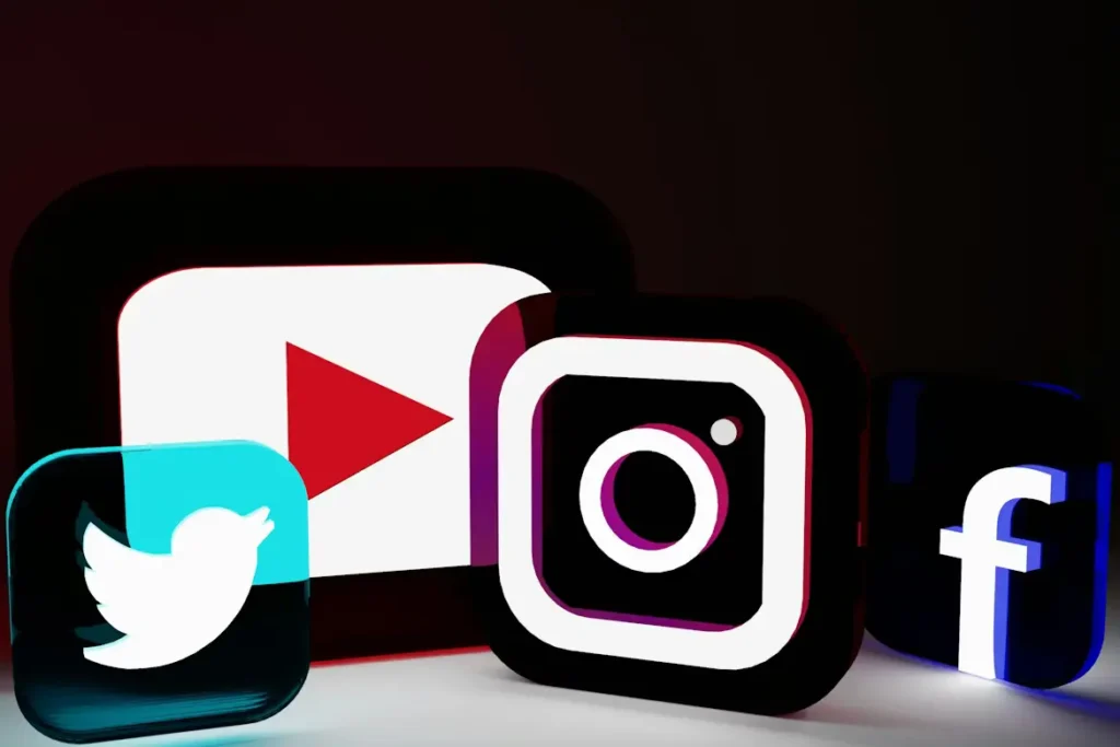 Stylized, illuminated social media logos of Instagram, Facebook, and YouTube, symbolizing a professional digital ecosystem and cross-platform social media strategy. logo designing in siliguri
